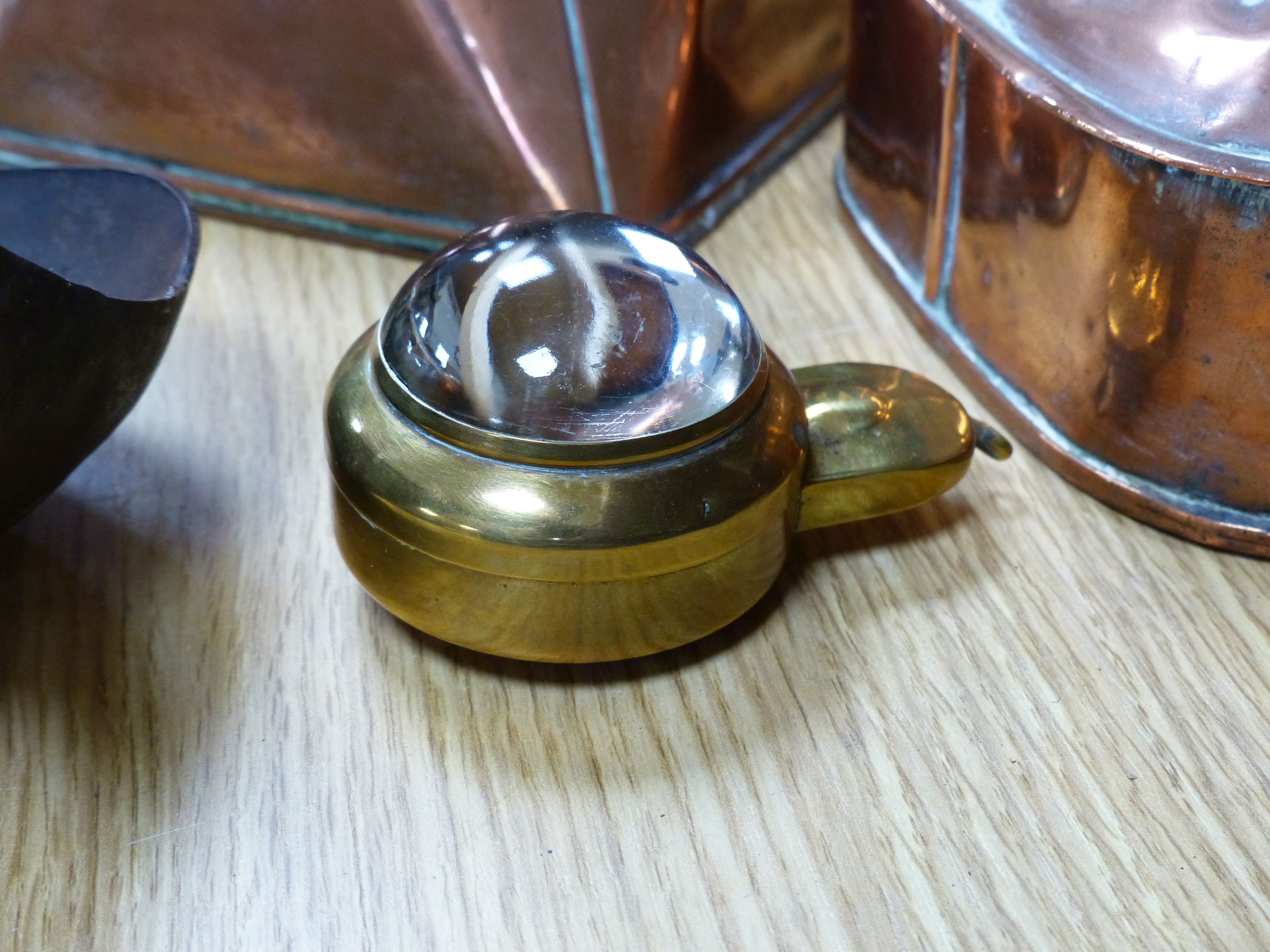 Two copper kettles, a beer slipper, iron ladle and a bull's eye lens